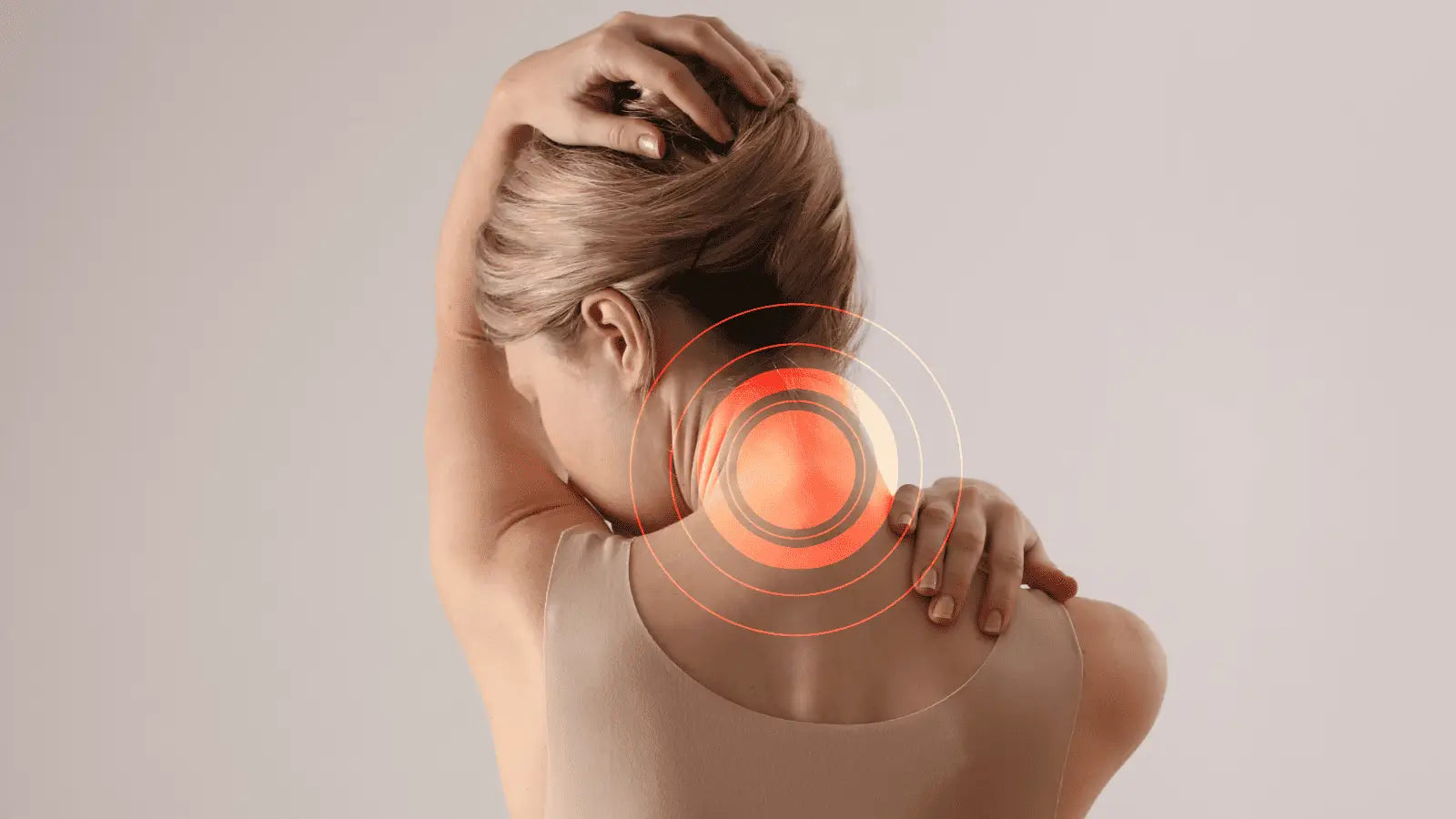Woman experiencing neck pain from using a massage gun on sensitive areas