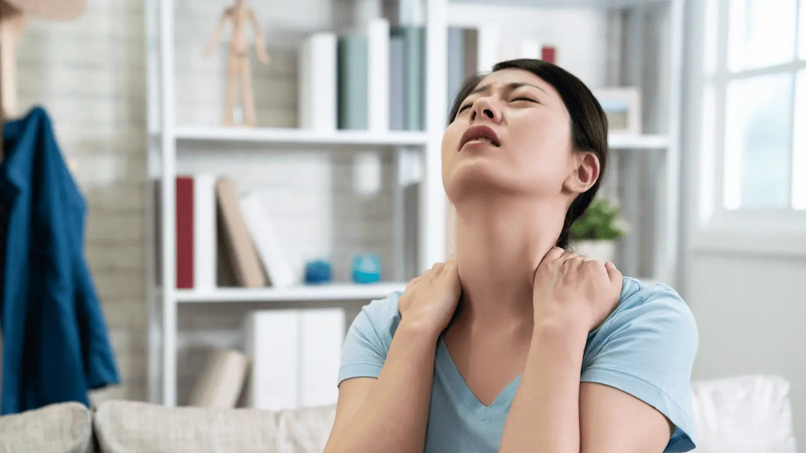 Woman experiencing neck pain due to massage gun usage highlighting nerve damage concerns