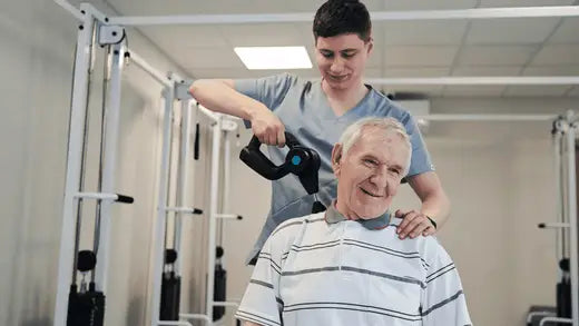 Elderly man enjoying muscle recovery with a massage gun treatment in an article about HSA.