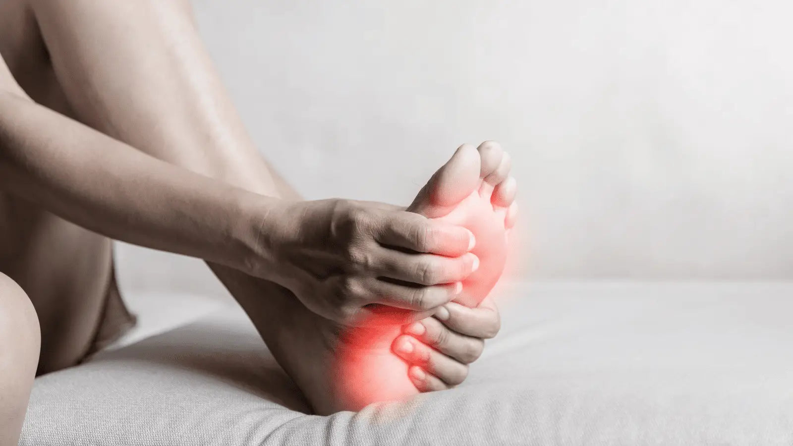 Foot with red pain points from plantar fasciitis, massage gun relief