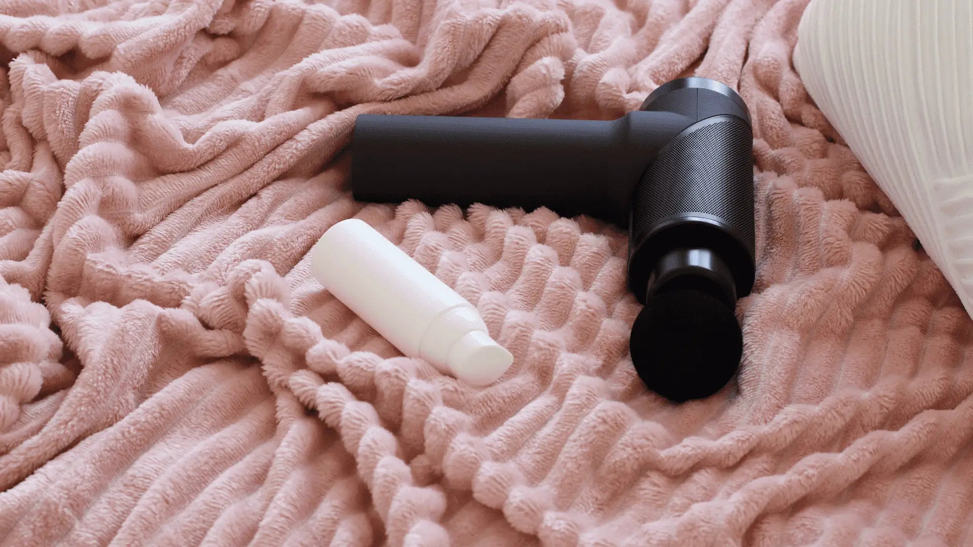 Black massage gun aiding muscle recovery