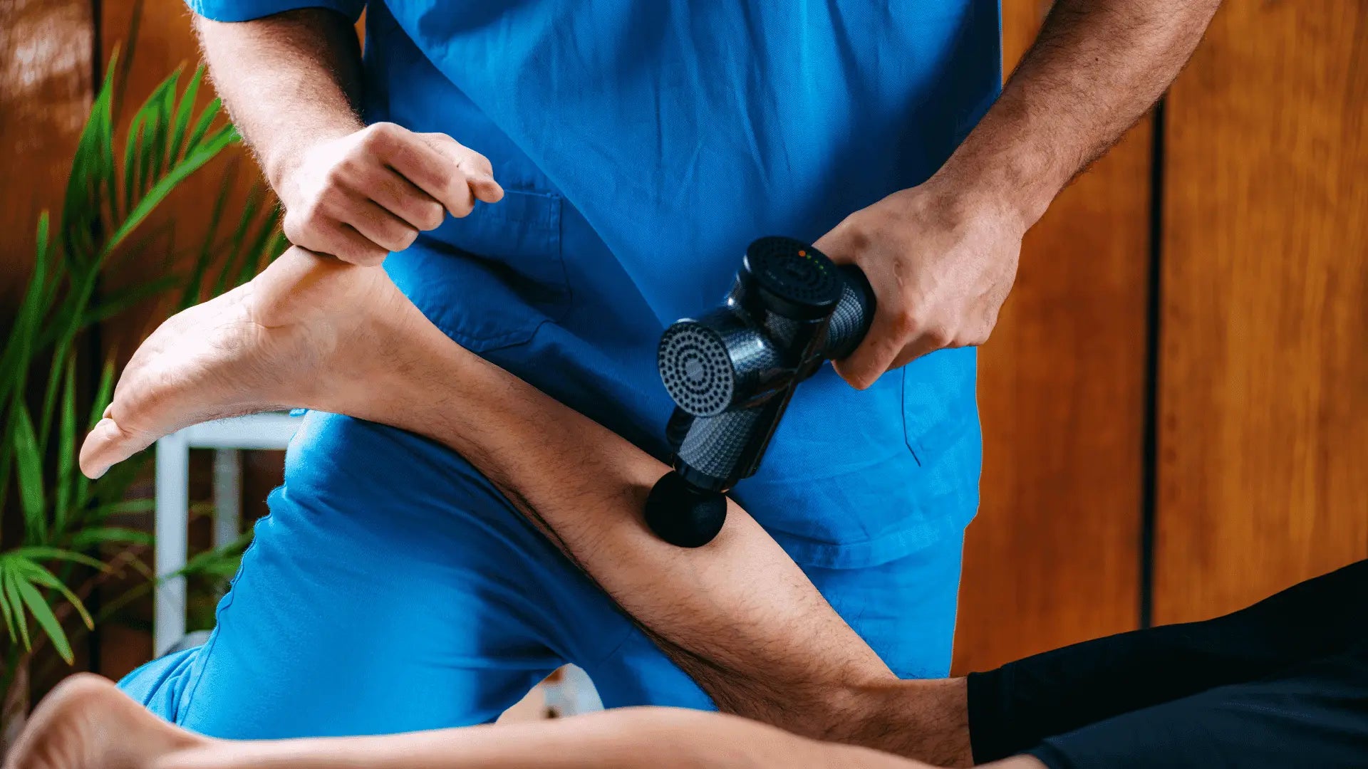 Massage gun on leg for improved blood flow and muscle recovery after quad workout