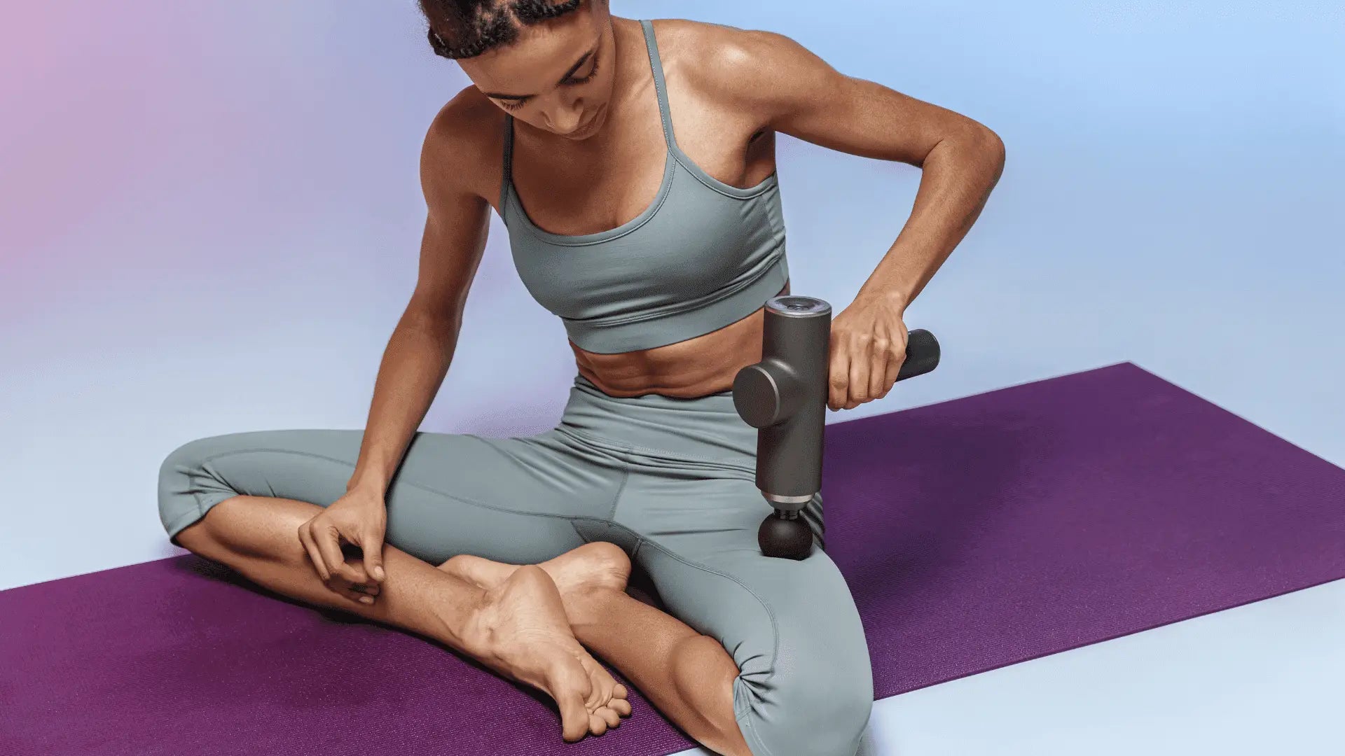 Gray massage gun to improve blood flow and relax muscles in leg therapy
