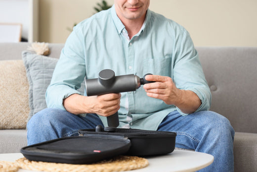 Gray massage gun displayed in an article about how much is a massage gun including Theragun Pro