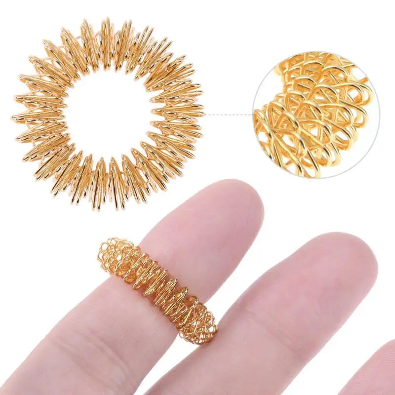 Gold acupressure ring with spiral finger massage design