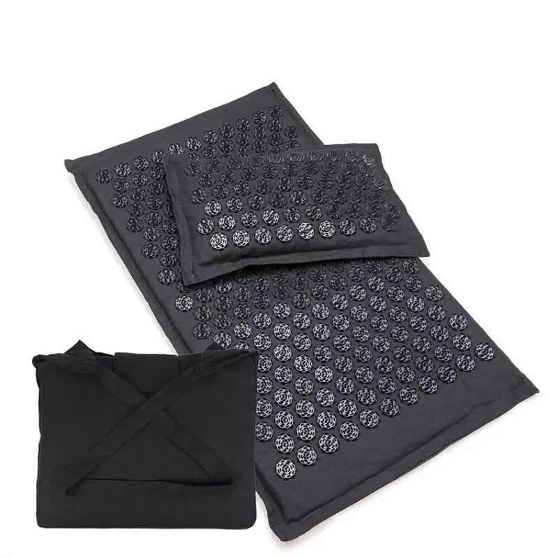 Deep black acupressure mat with silver rose-like grid studs