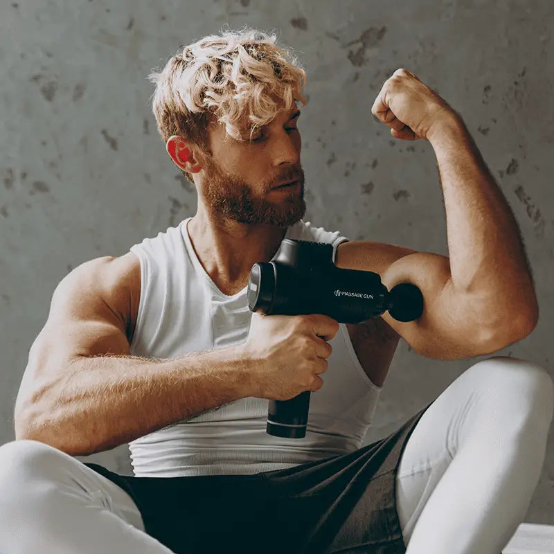 Black percussion massage gun for muscle recovery and relieving sore muscles