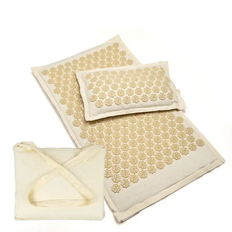 Off white acupressure mat with cream fabric and golden flower needles
