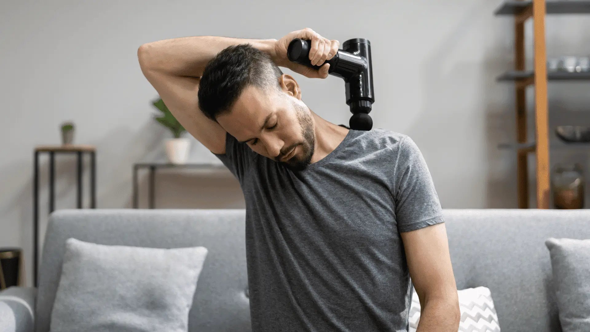 Black massage gun used for effective percussive therapy in massage guns treatments