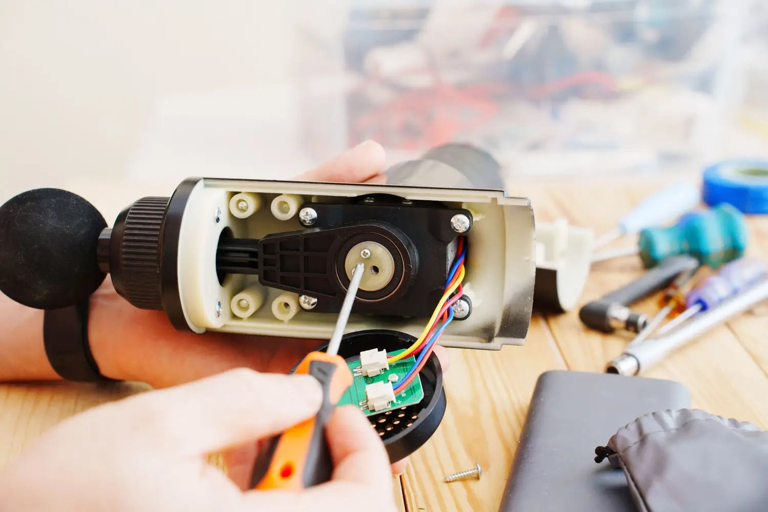 Disassembled anemometer being repaired with focus on massage gun power switch and customer support