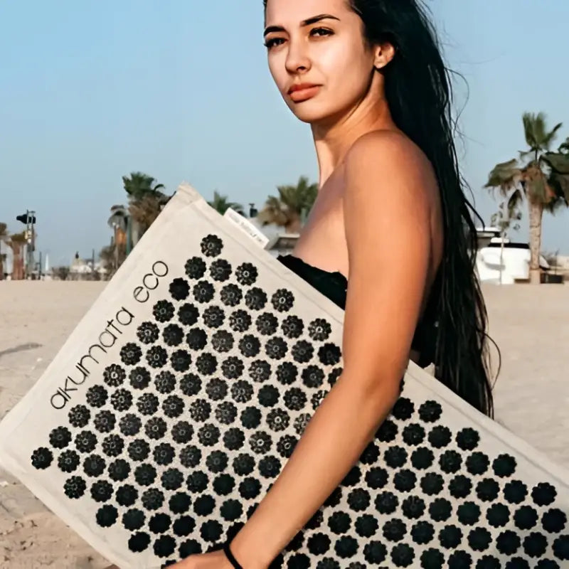 Black acupressure mat Akumata ECO with hexagonal nubs on beige base