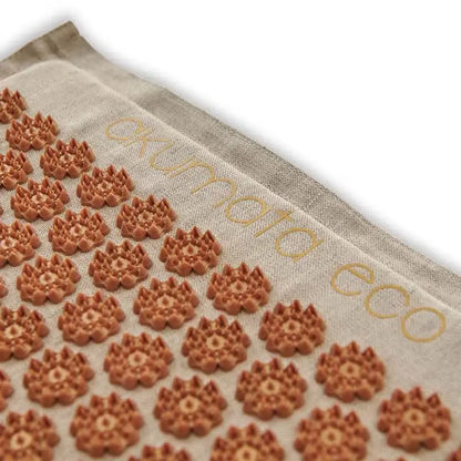 Light-colored brown acupressure mat with spiky lotus-shaped discs for relaxation and pain relief