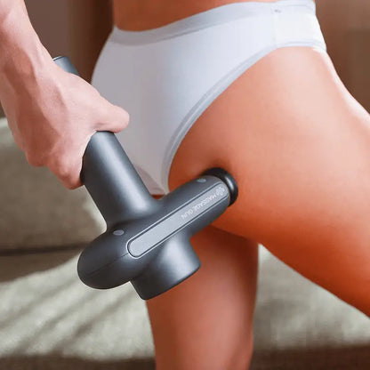 Gray massage gun for muscle recovery with ergonomic design for effective therapy